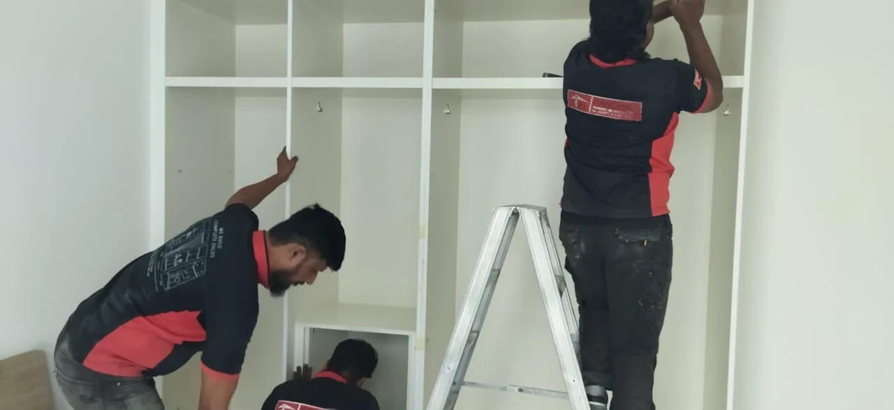 Time Furniture team installing fitted wardrobe shelving