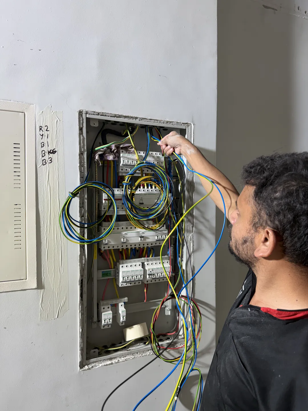 Time Furniture technician working on an electrical controls panel