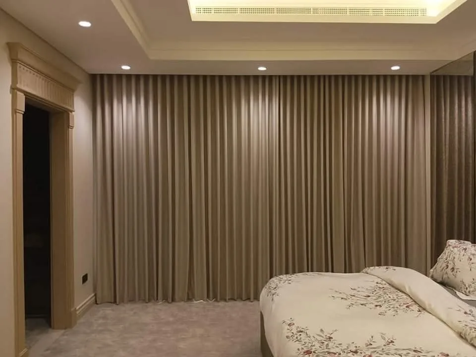 Floor-to-ceiling ripple-fold curtains and sheer window dressing